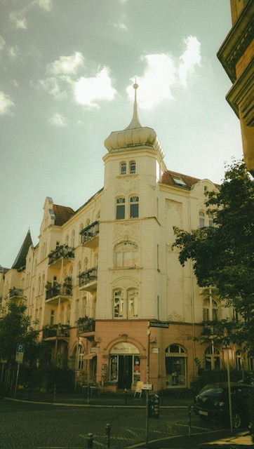 German historic corner building with turret, Art Nouveau detailing and terracotta roof