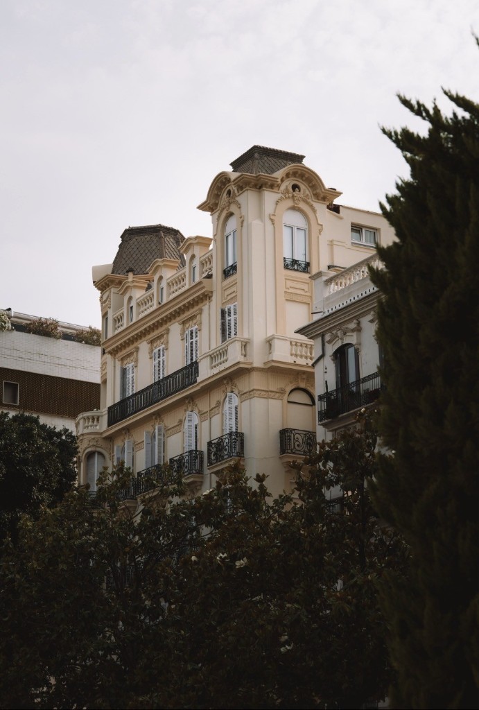 Classic Spanish cream apartment building with wrought-iron balconies
