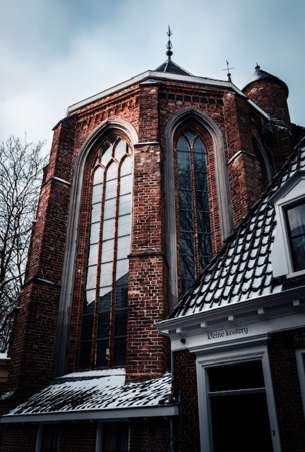 Historic Dutch red-brick architecture with Gothic arched windows